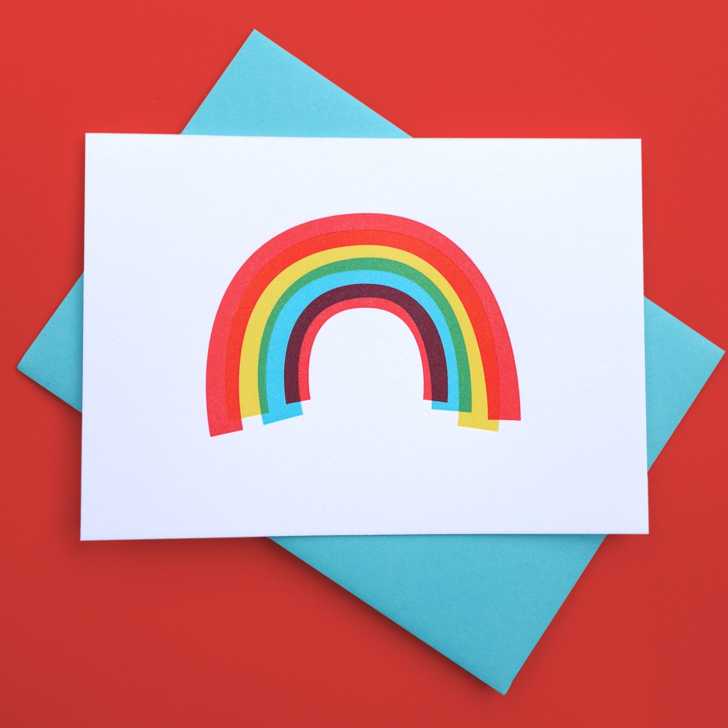 A white greeting card with a rainbow