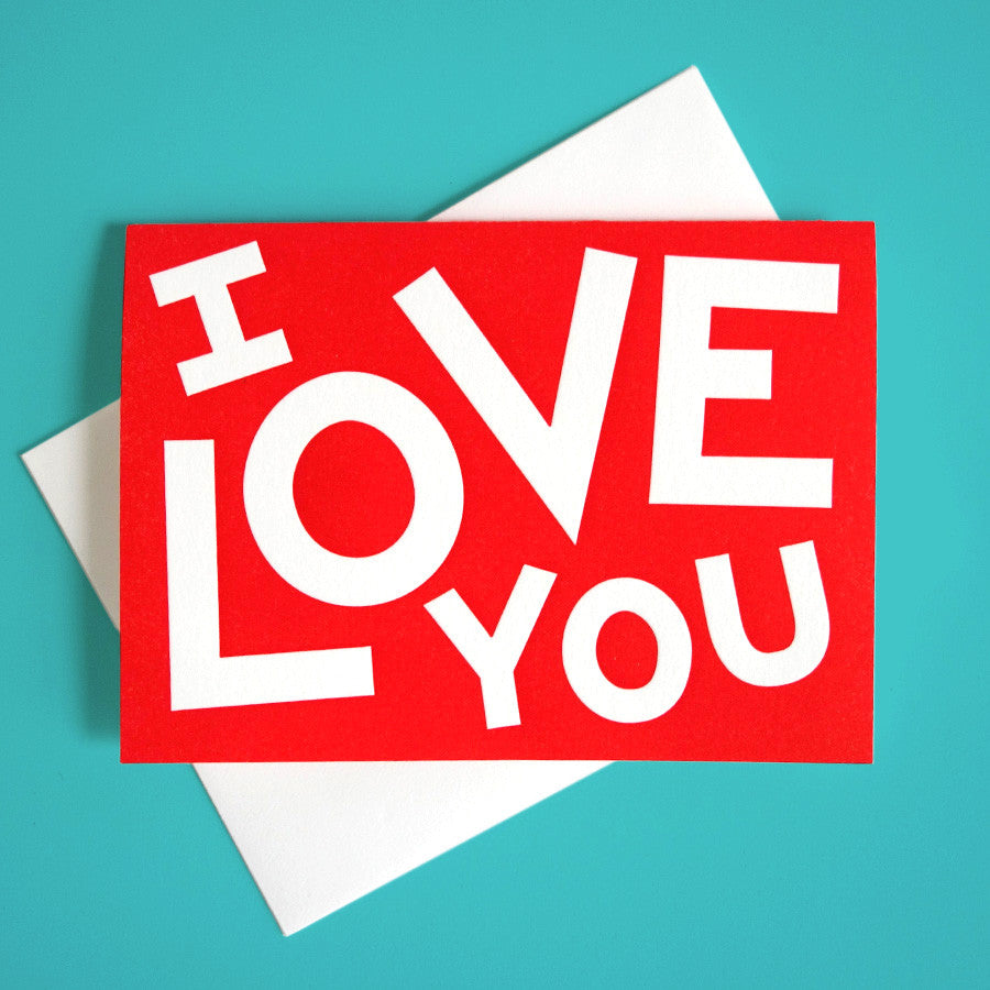 A bright red greeting card that reads "I Love You"